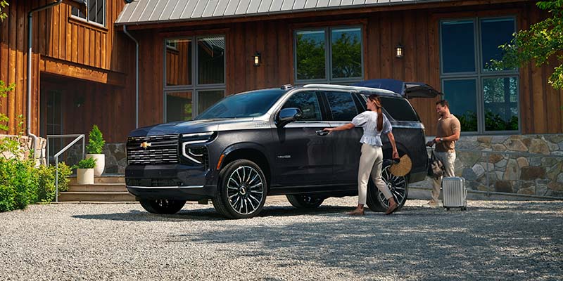 Black Chevrolet SUV at cabin driveway