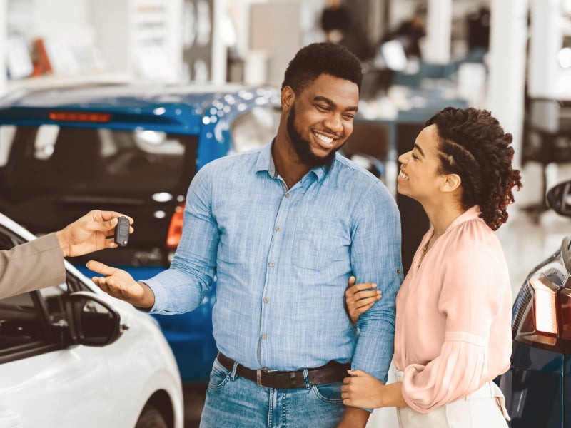 Image of a man inspecting the engine with the device connected to the phone