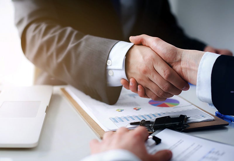 Image of handshake, customer with finance team member